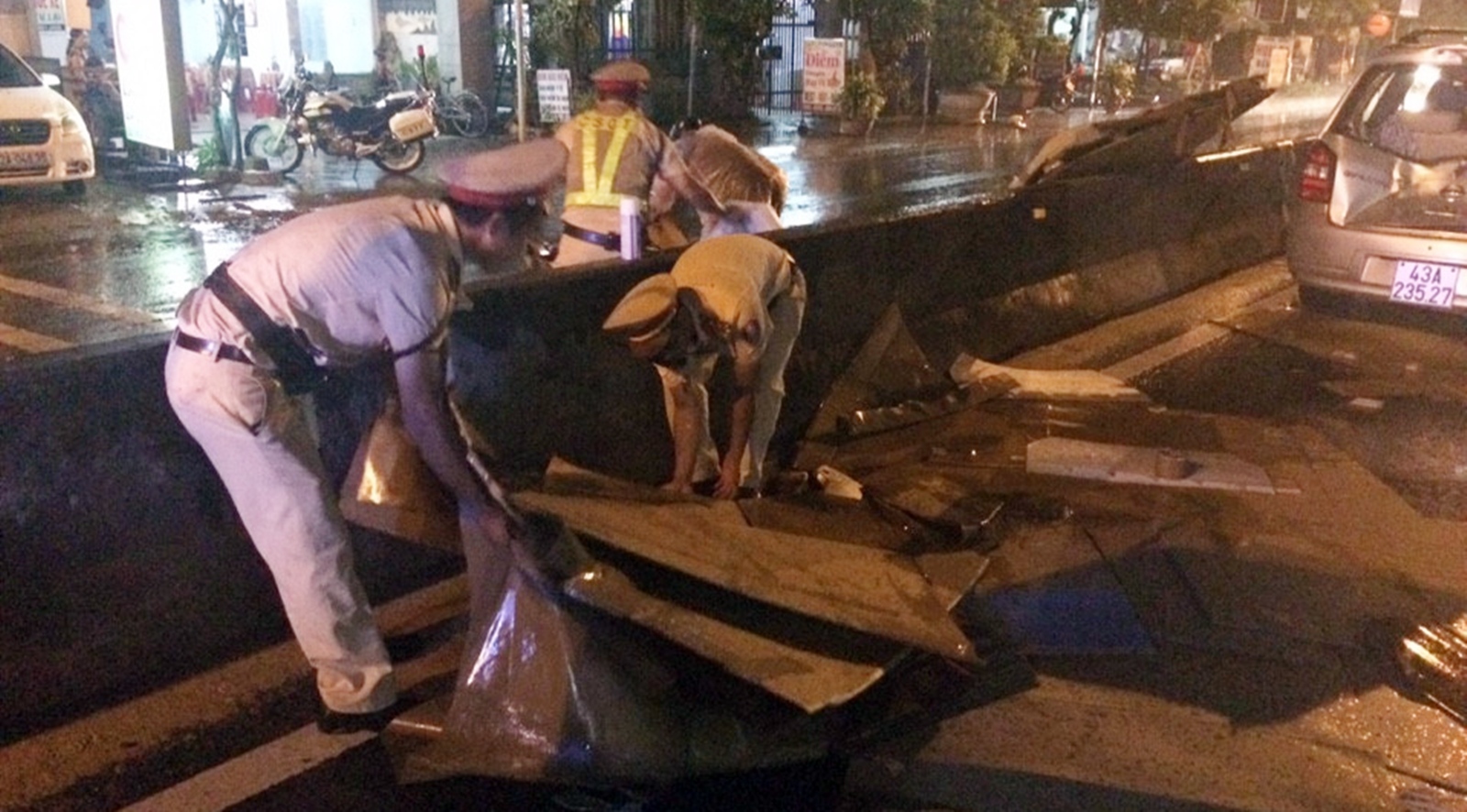 CSGT dầm mưa dọn dẹp thùng giấy cát-tông đổ ra đường gây tai nạn