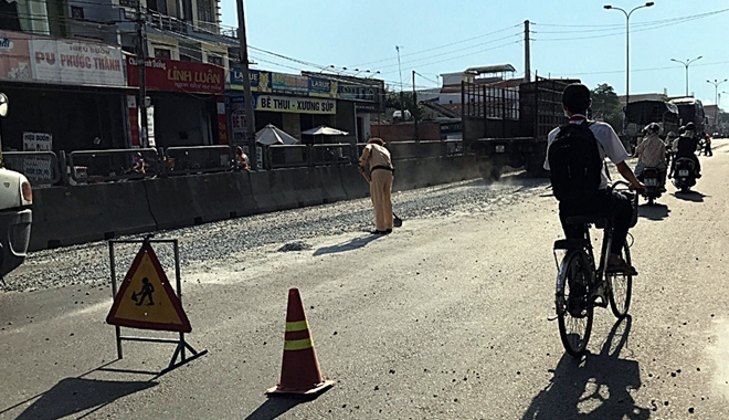 CSGT “đội nắng” dọn dẹp đá dăm rơi vãi trên quốc lộ - Ảnh minh hoạ 2