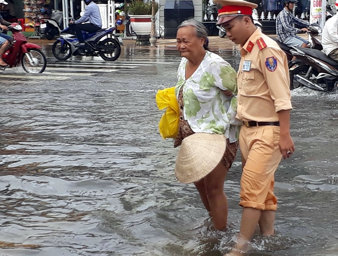 Cảnh sát giao thông giúp dân qua những đoạn đường ngập sâu - Ảnh minh hoạ 6