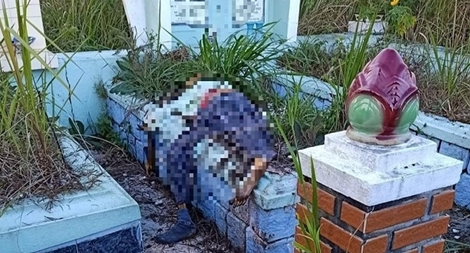 Thi thể đã phân hủy nằm trên ngôi mộ