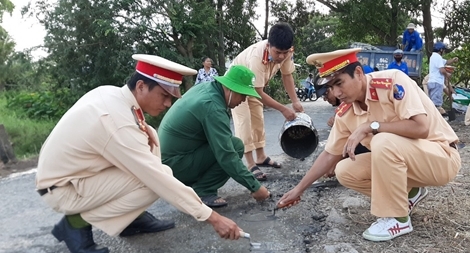 CSGT huyện sửa đường để người dân đi lại an toàn